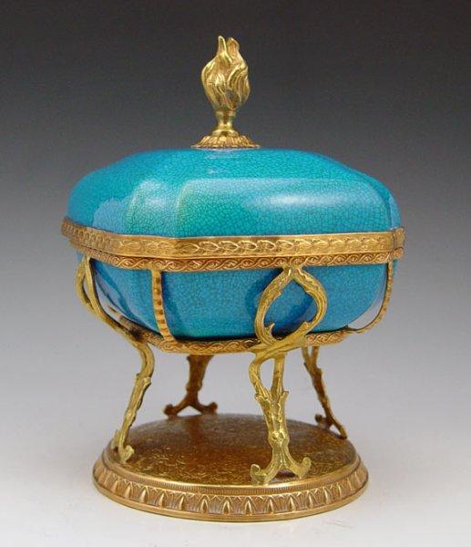 Appraisal: ORMOLU MOUNTED BOCH FRERES COVERED JAR Flame finial covered box