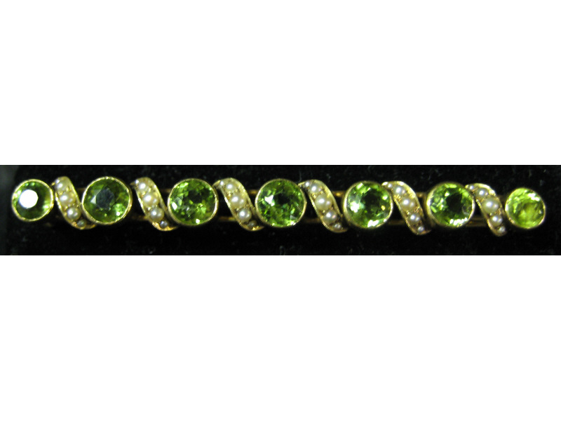 Appraisal: PERIDOT AND SEED PEARL BROOCH k yellow gold bar pin