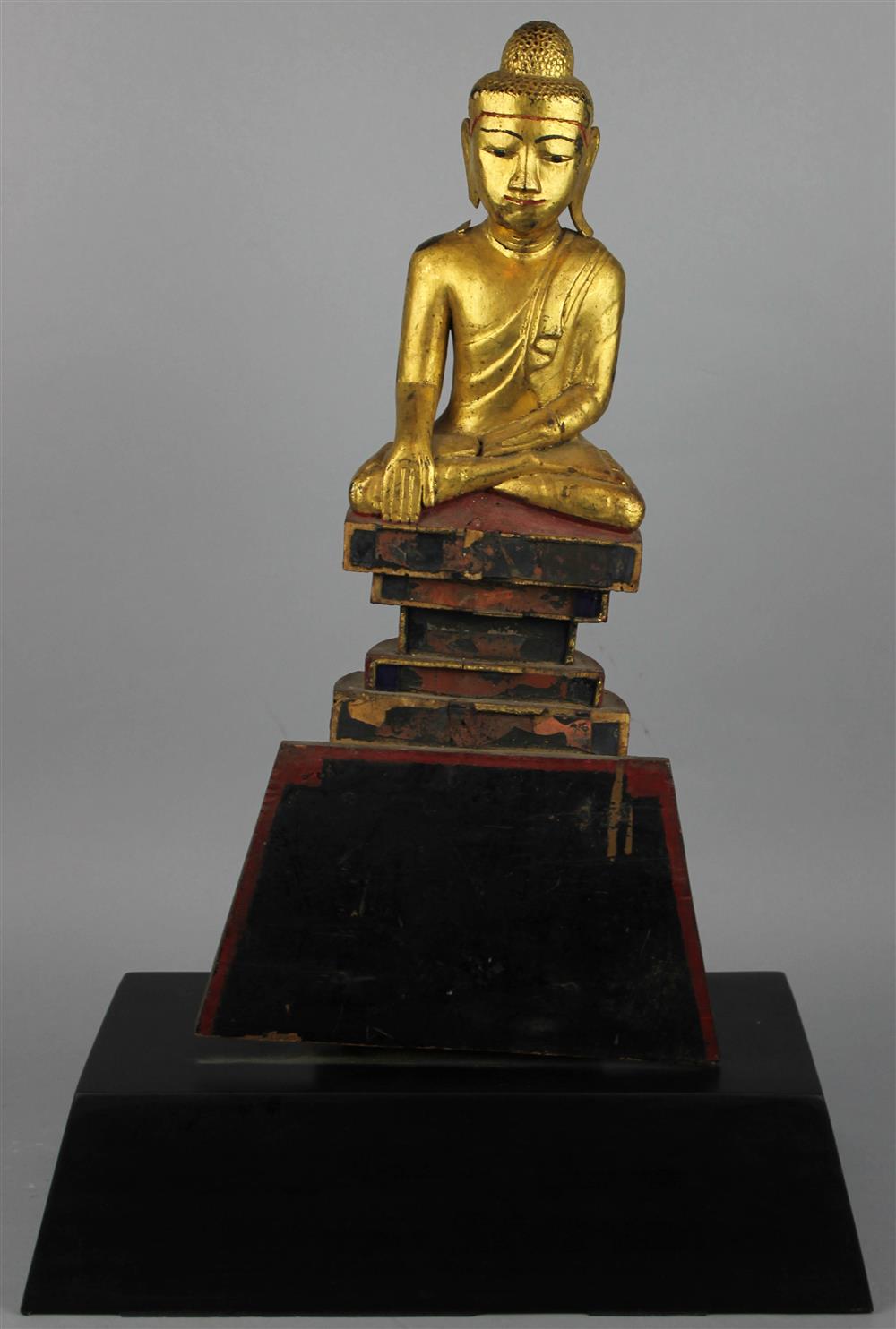 Appraisal: BURMESE GILTWOOD FIGURE OF A SEATED BUDDHA the figure seated