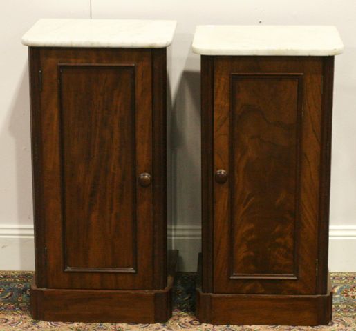 Appraisal: A pair of th century mahogany and marble topped bedside