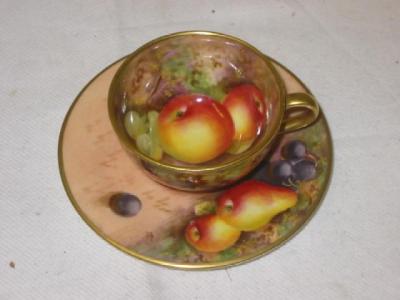 Appraisal: A ROYAL WORCESTER PORCELAIN MINIATURE CUP AND SAUCER painted with