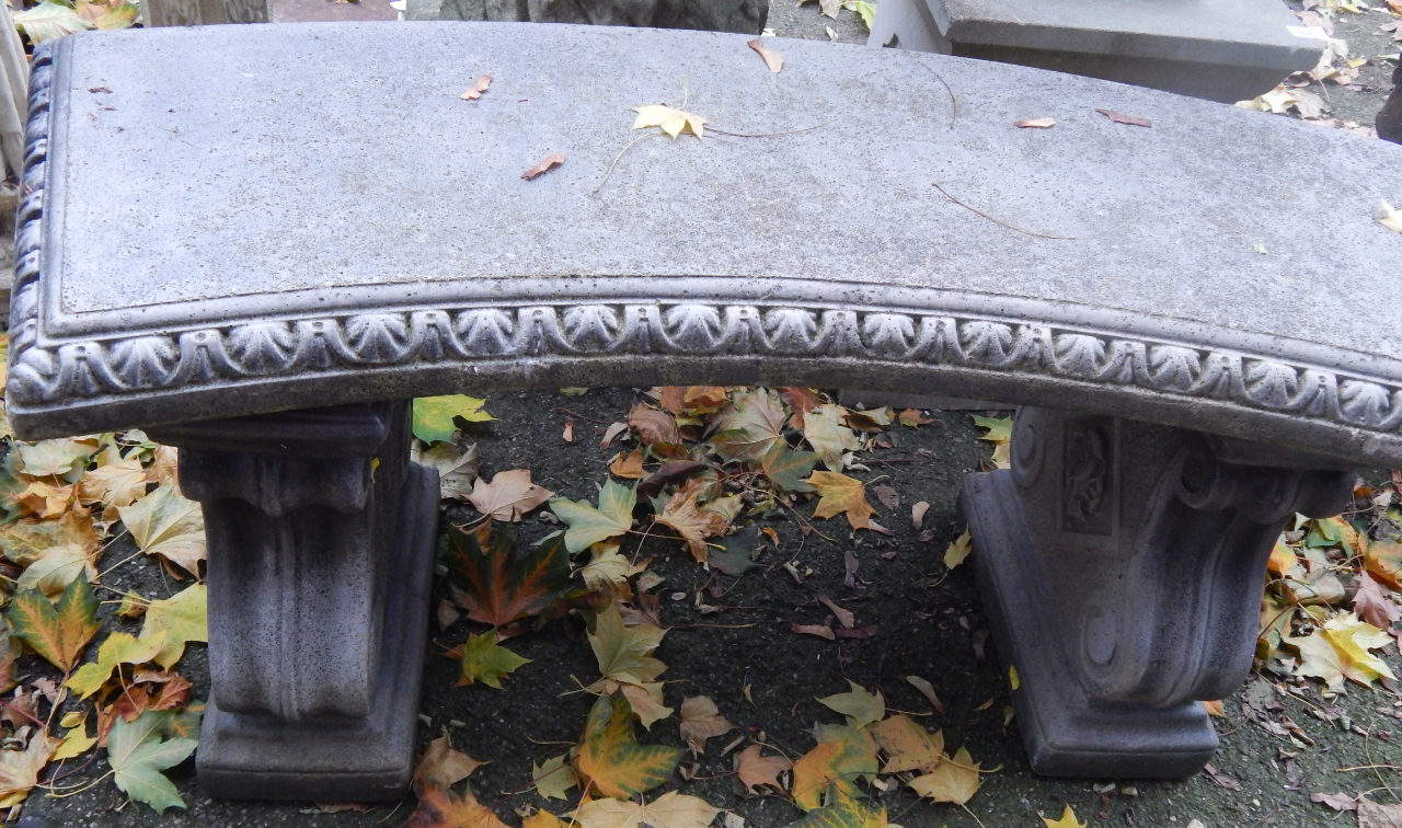 Appraisal: A curved concrete bench raised on scroll end supports cm