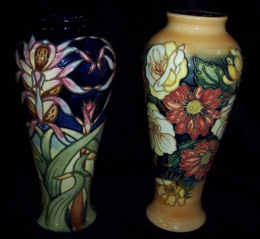 Appraisal: A Moorcroft slim baluster vase painted orchids on a blue