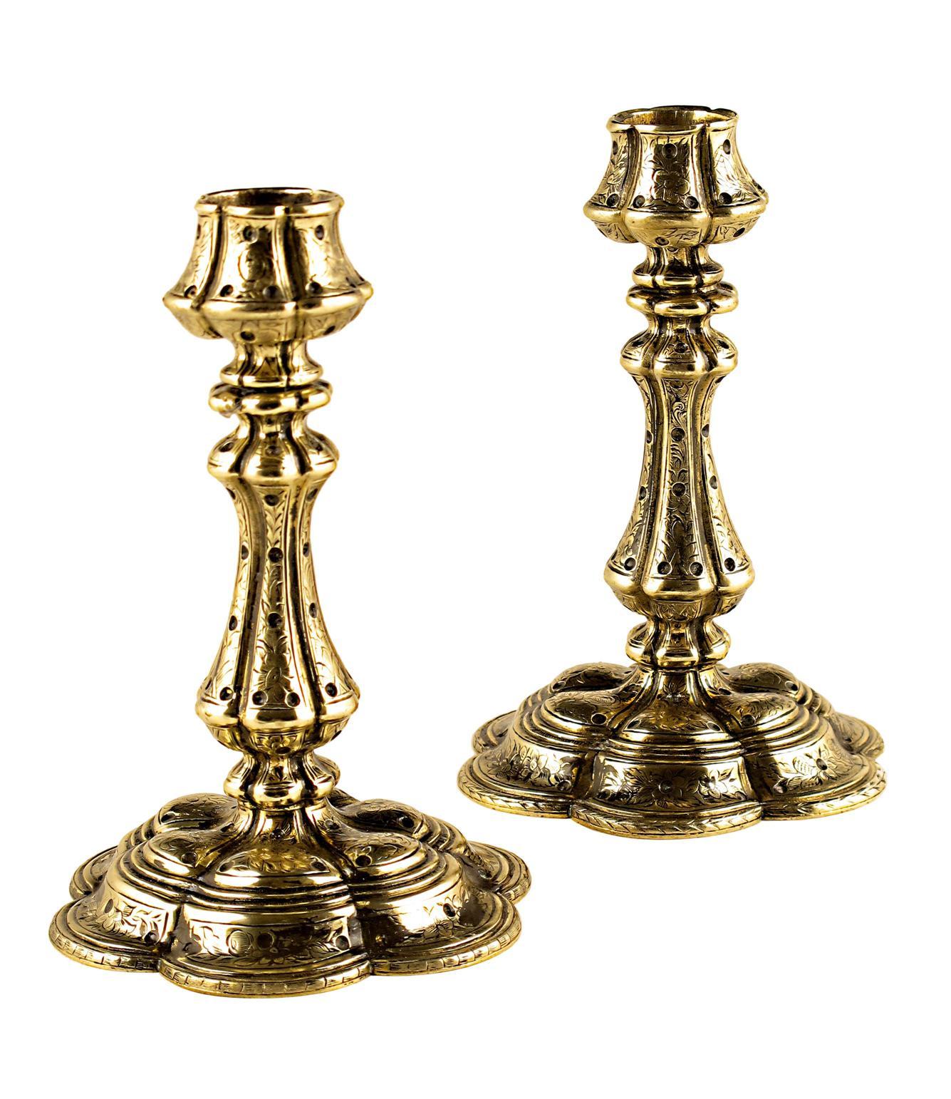 Appraisal: A pair of brass petal shaped candlesticks