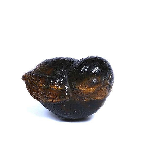 Appraisal: A SMALL CARVED TIGERS EYE STONE SCULPTURE of a bird