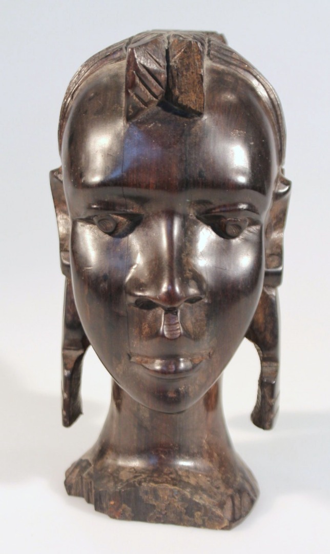 Appraisal: A thC African hardwood tribal head carved as a lady