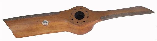 Appraisal: A TRUNCATED LAMINATED MAHOGANY TWO BLADE PROPELLER the blades with