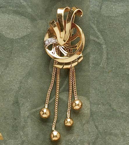 Appraisal: DIAMOND TASSSLE BROOCH k yellow gold brooch with swirl designs