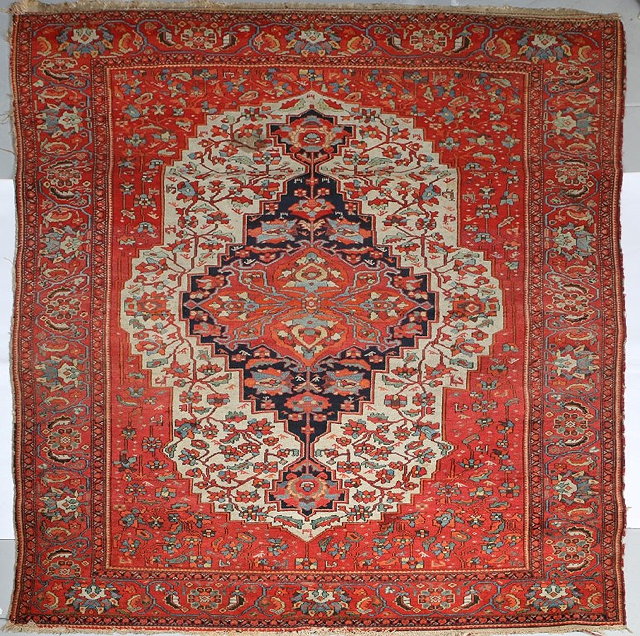 Appraisal: A MALAYER RUST GROUND RUG with a central deep blue