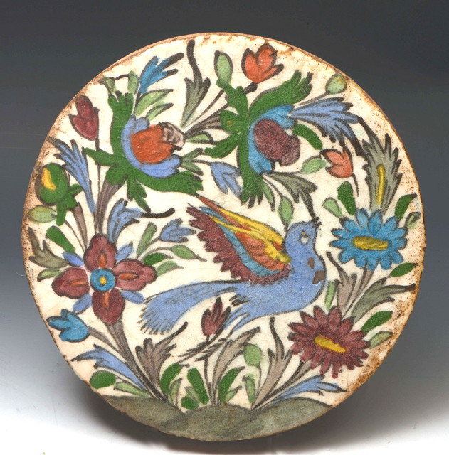 Appraisal: AN ORIENTAL POSSIBLY ISLAMIC CIRCULAR STONEWARE PLAQUE decorated in Iznic