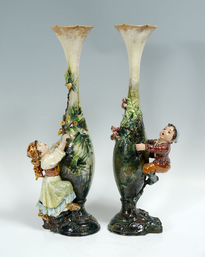 Appraisal: PAIR CONTINENTAL FIGURAL FAIENCE TALL VASES One with figure of