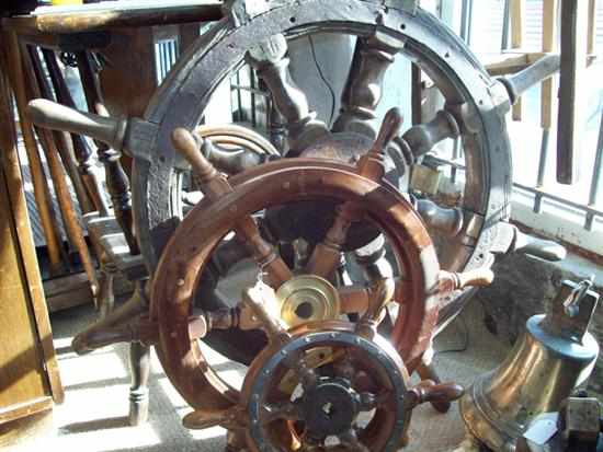 Appraisal: A SHIP STEERING WHEEL AND THREE LATER SHIP WHEELS