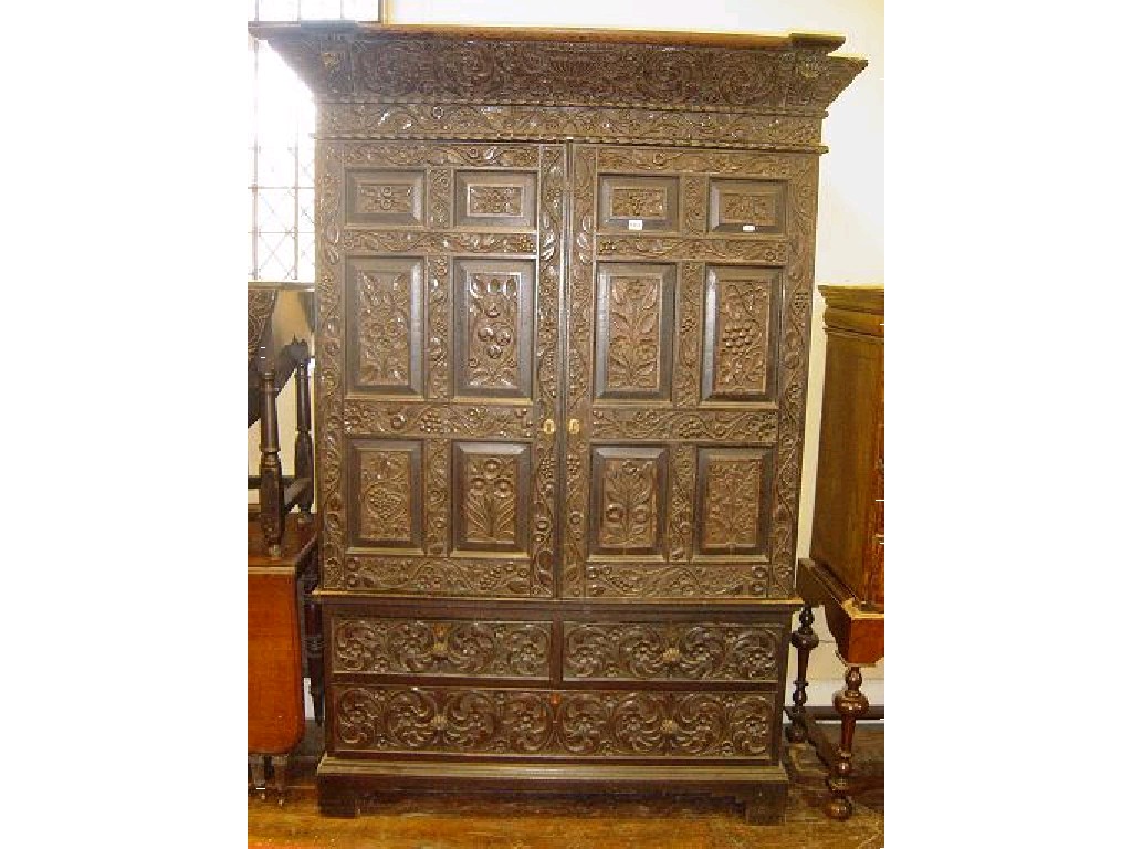 Appraisal: A th century oak press cupboard enclosed by a pair