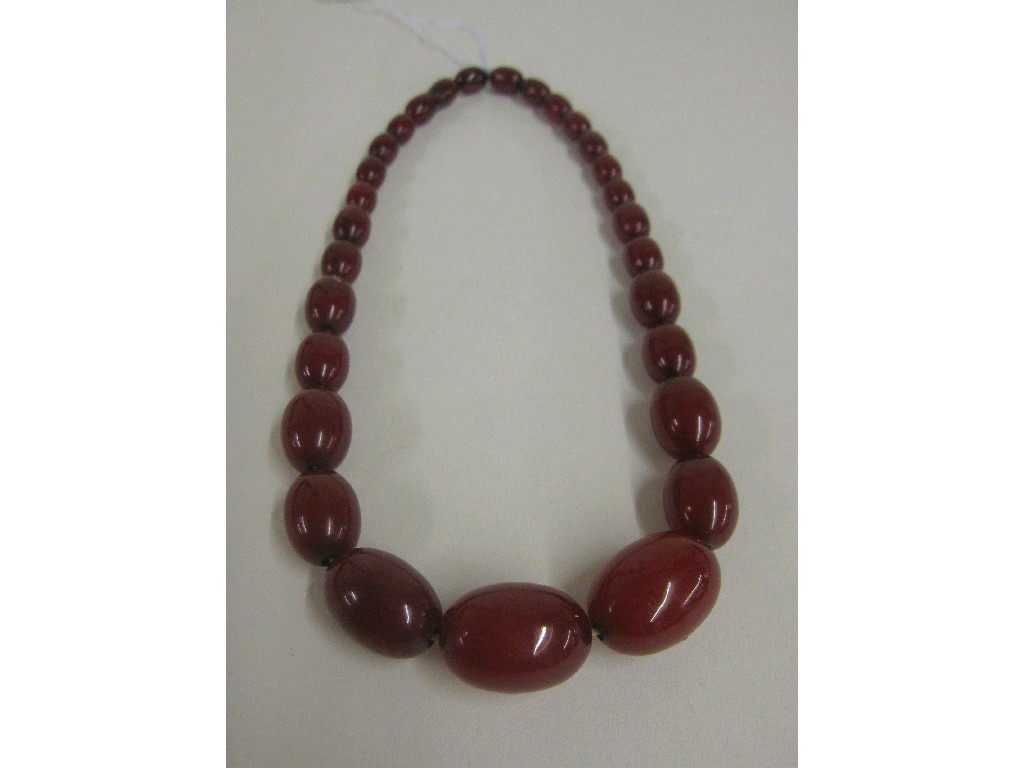 Appraisal: String of red amber beads Approx cm