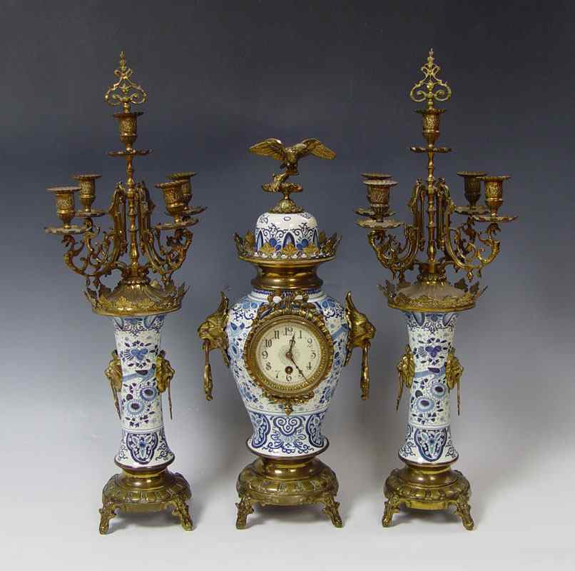 Appraisal: DELFT PIECE CLOCK GARNITURE SET Delft porcelain body with applied