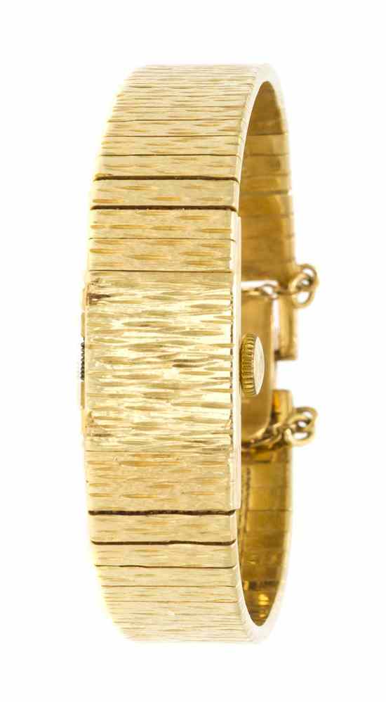 Appraisal: A Karat Yellow Gold Surprise Wristwatch Baume Mercier textured rectangular