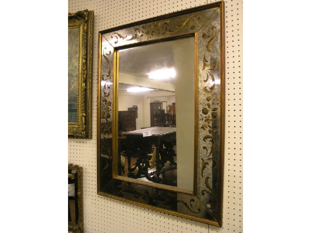 Appraisal: A reproduction wall mirror the distressed mirror borders gilded with