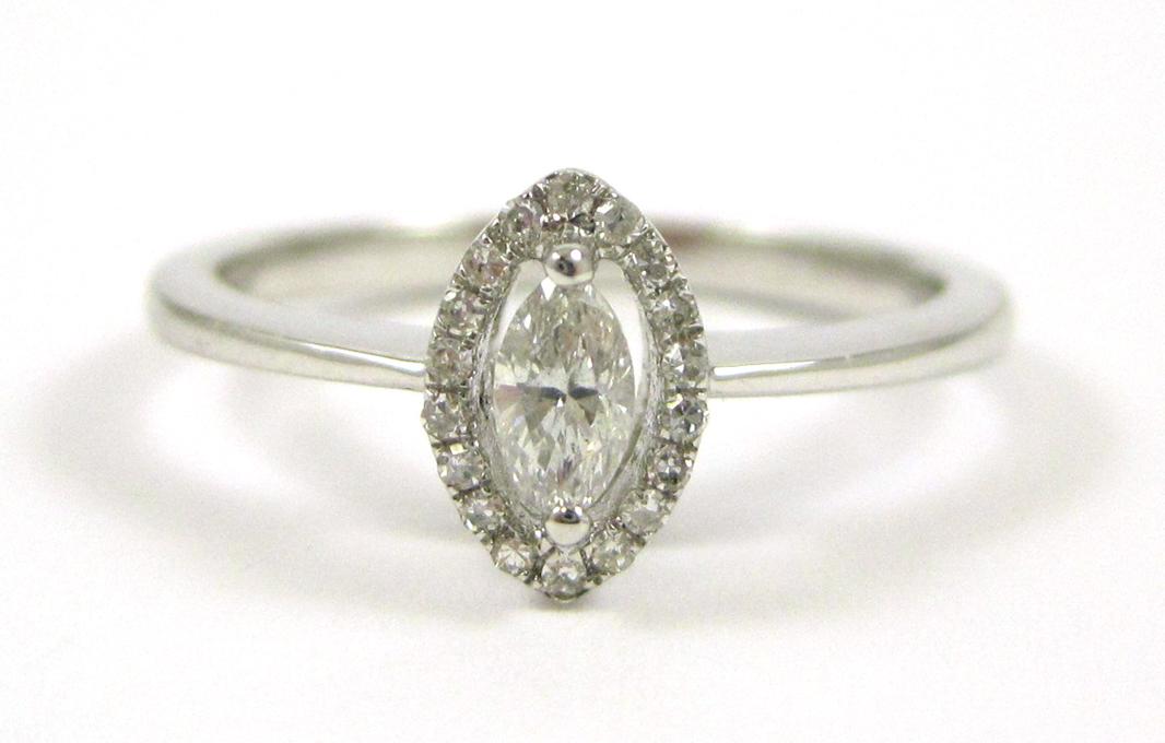 Appraisal: DIAMOND AND FOURTEEN KARAT WHITE GOLD RING with round-cut diamonds