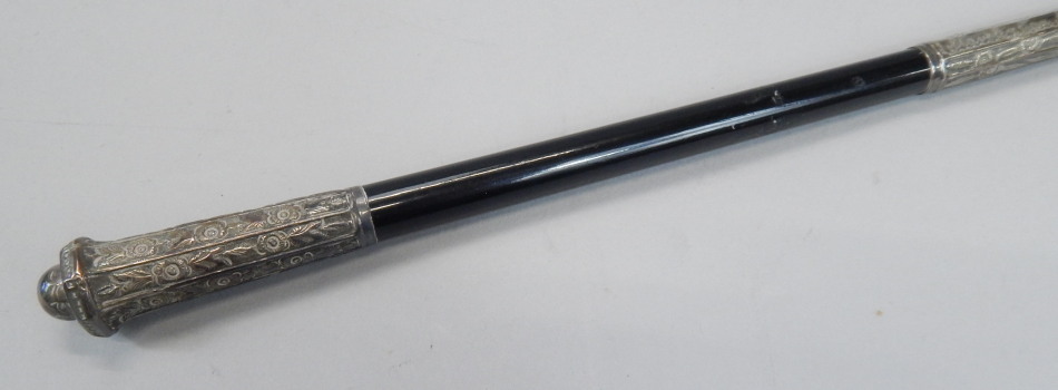 Appraisal: An ebonised conductor's baton with white metal mounts