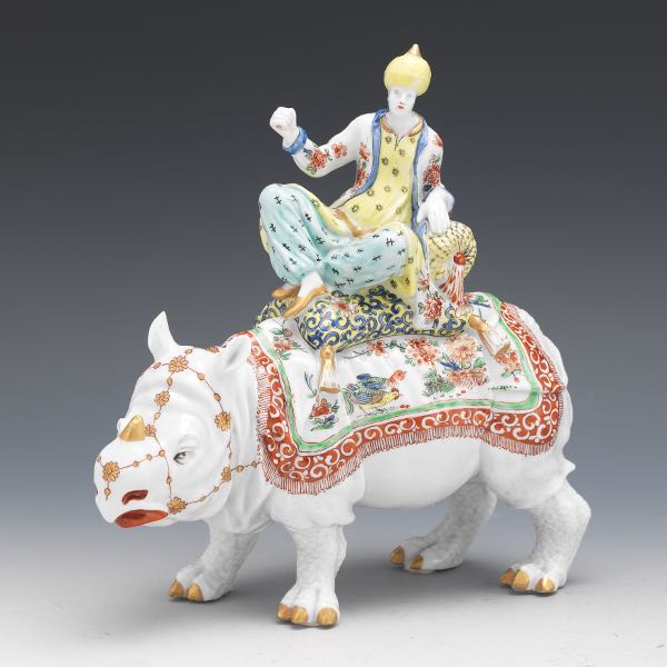 Appraisal: PORCELAIN RHINOCEROS AND FIGURAL GROUP x x In the style