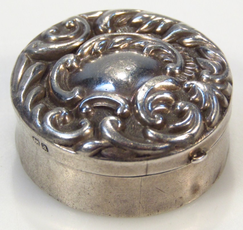 Appraisal: A Victorian silver patch box the repouss decorated lid set