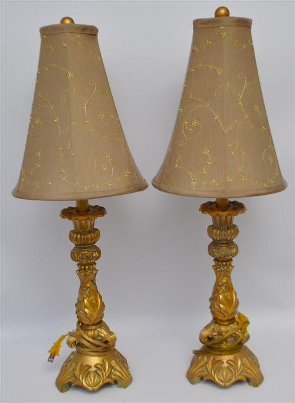 Appraisal: PAIR ORNATE VINTAGE GILT TABLE LAMPS A matched pair of