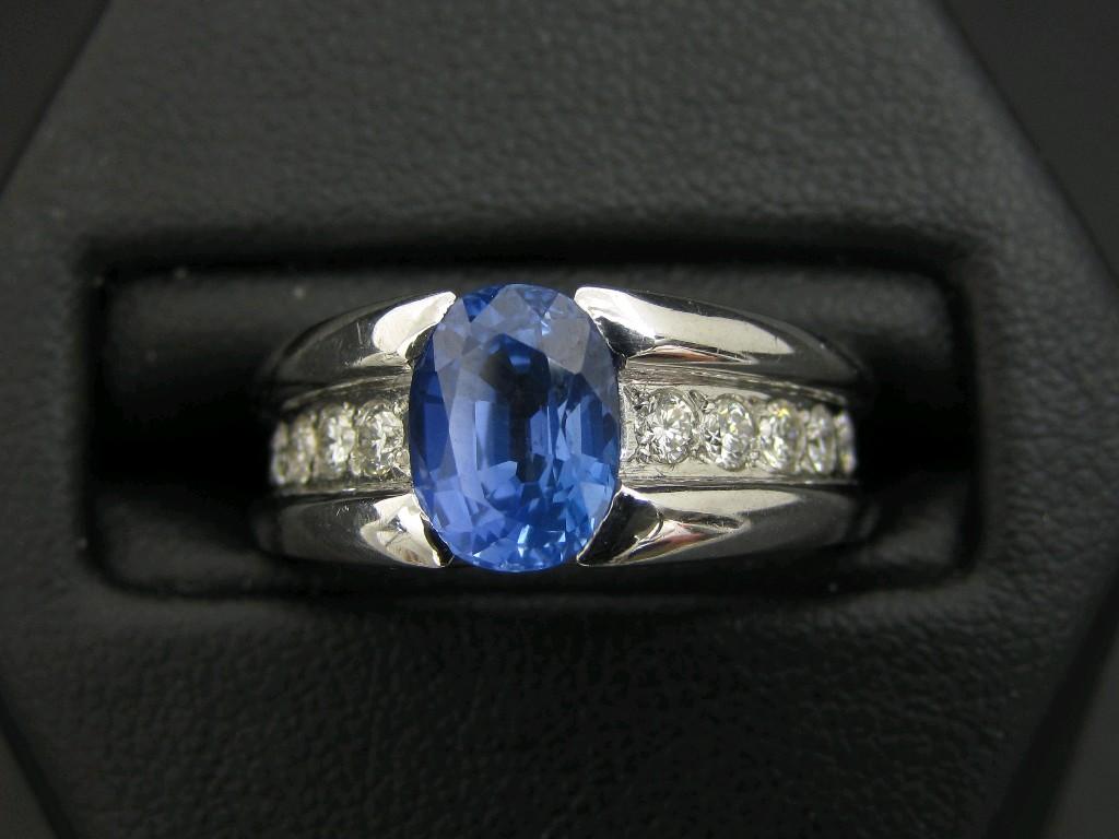 Appraisal: A Contemporary Sapphire and Diamond Ring set central oval-cut sapphire