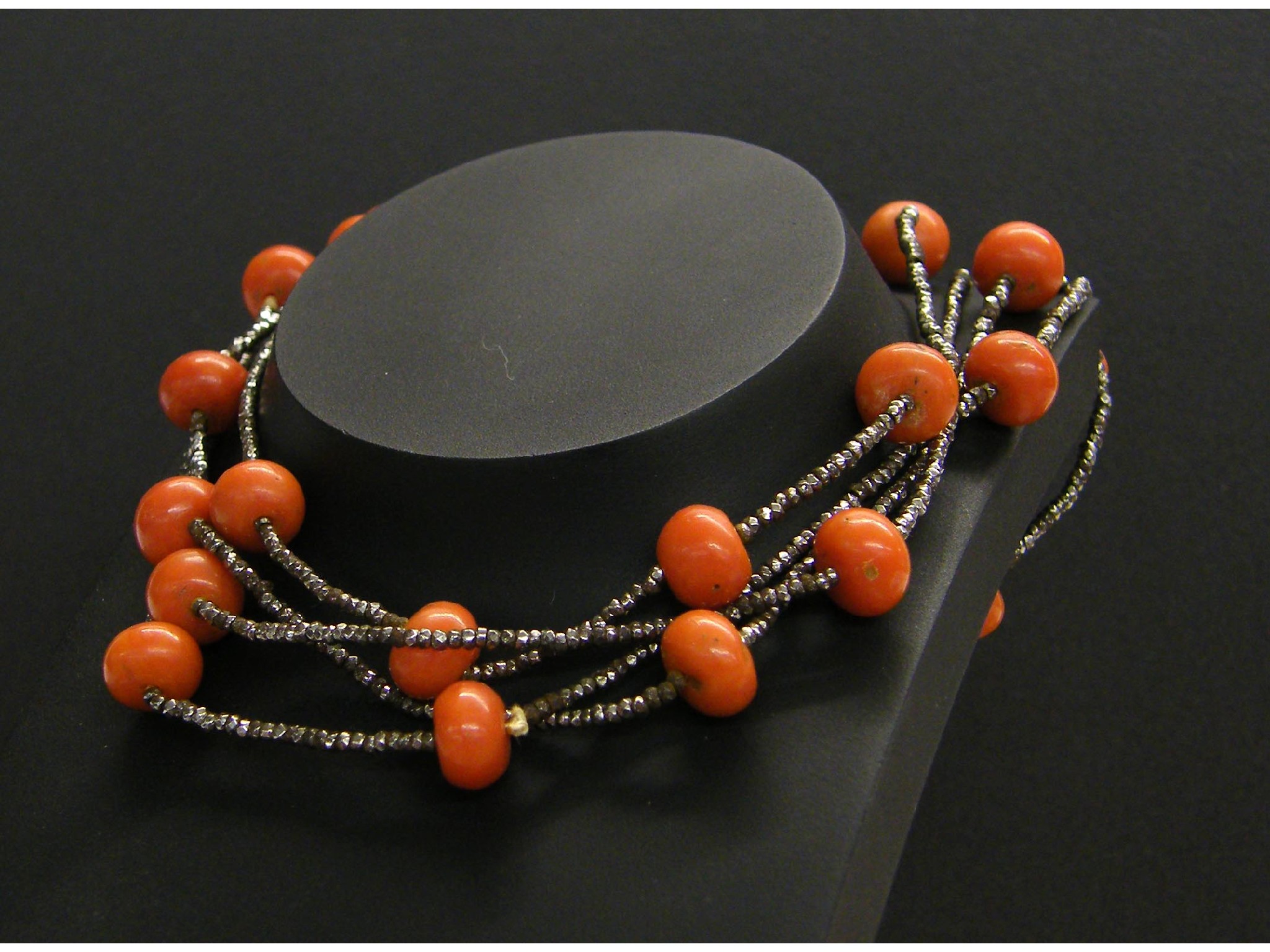 Appraisal: Coral bead and steel long necklet gm long