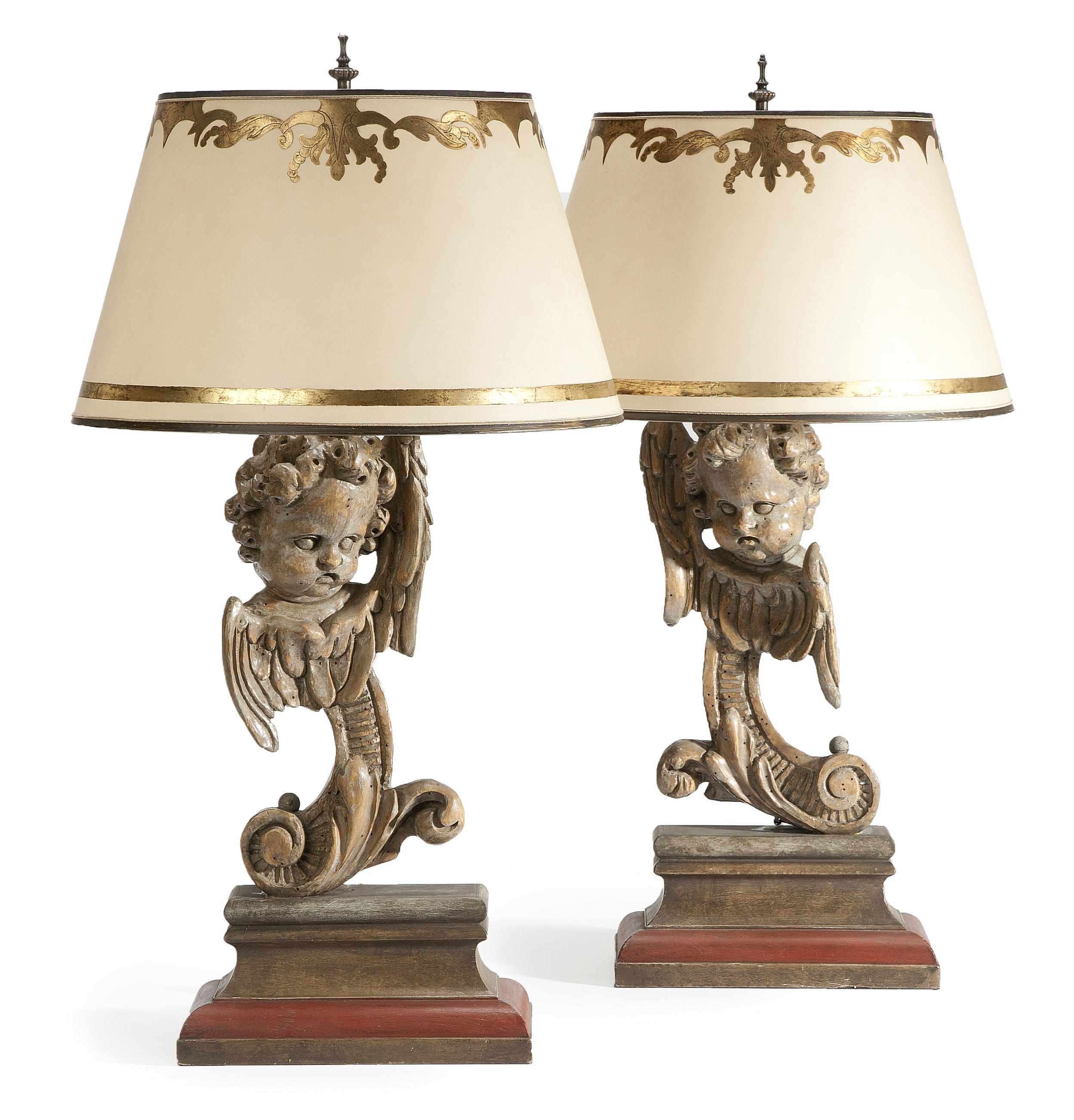 Appraisal: A pair of Baroque style carved silvered wood table lamps