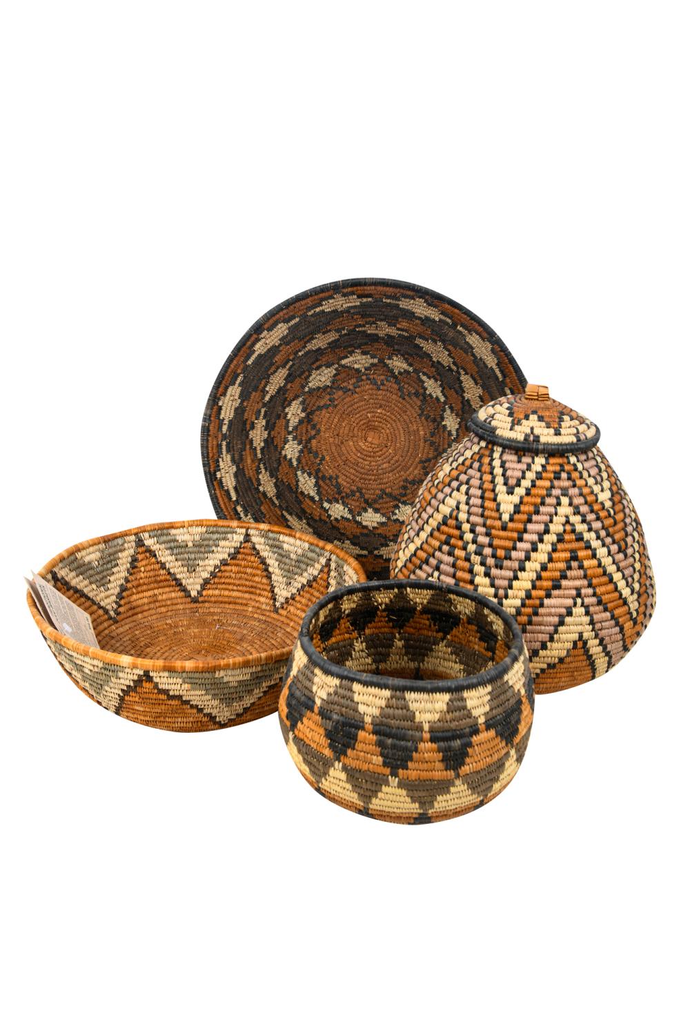 Appraisal: SET OF FOUR WOVEN STRAW ZULU BASKETSwith tags covered basket