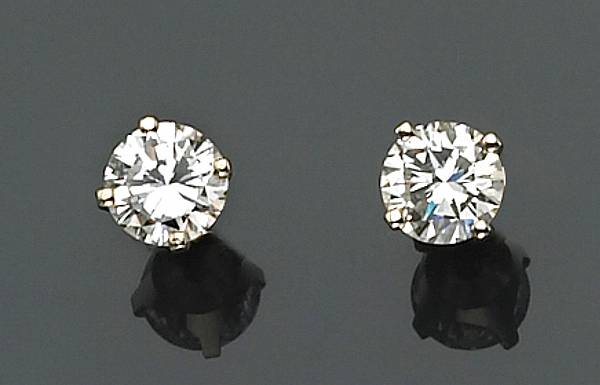 Appraisal: A pair of diamond and fourteen karat gold solitaire earrings