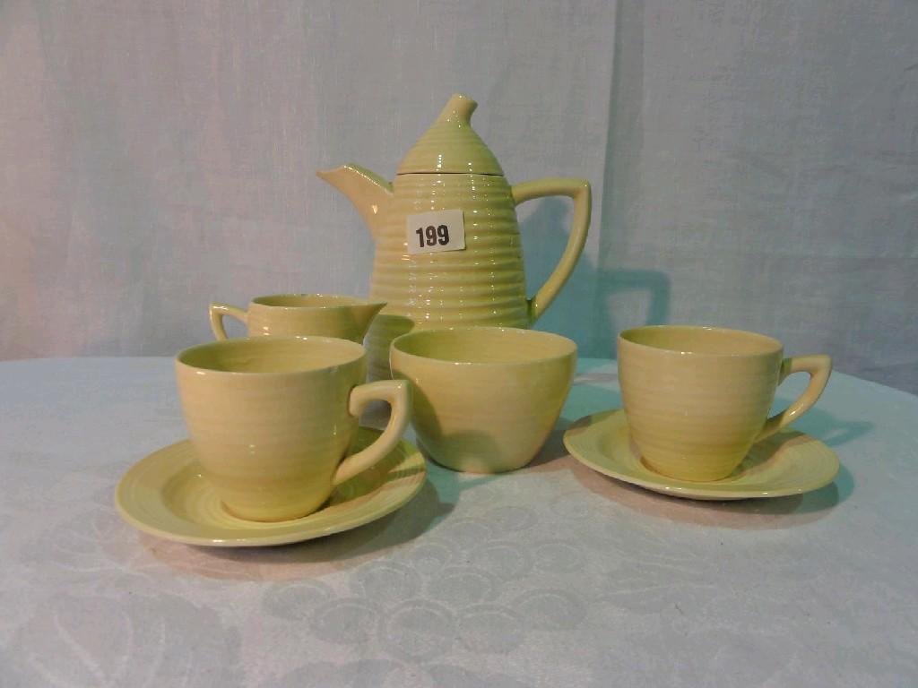 Appraisal: A Clarice Cliff coffee set with cream glaze and ribbed