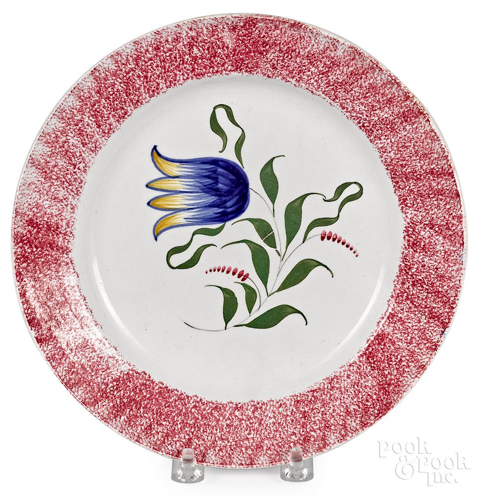 Appraisal: Red spatter plate with blue tulip Red spatter plate with