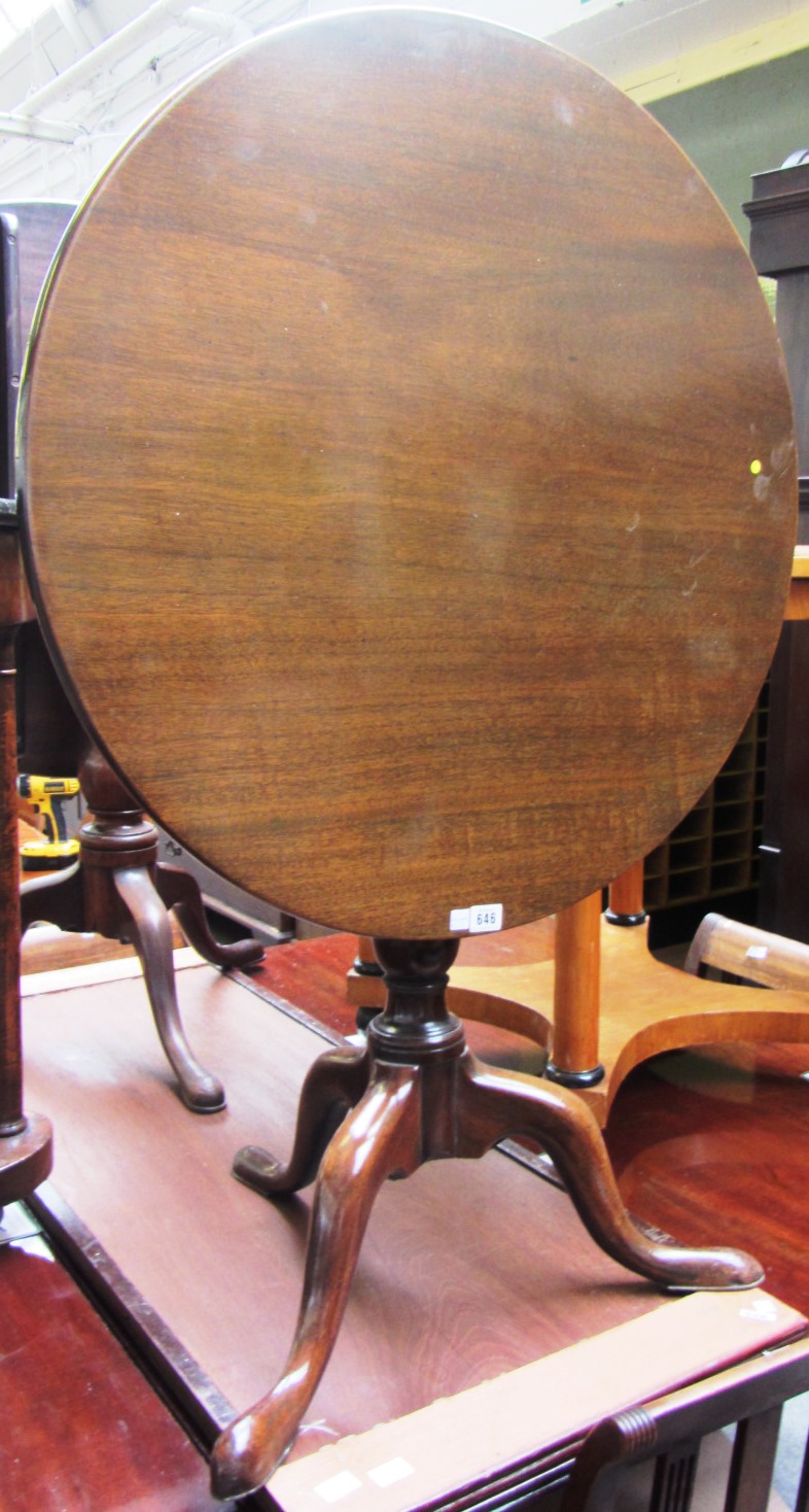 Appraisal: An th century mahogany circular snap top occasional table on