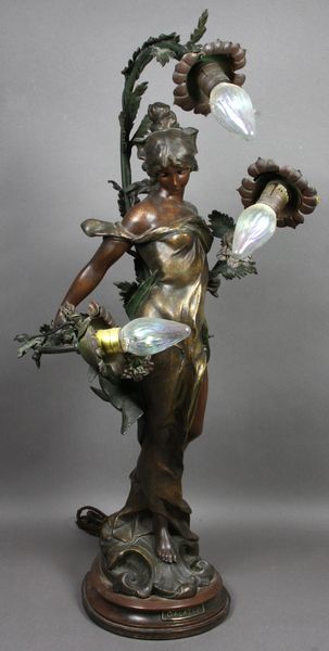 Appraisal: Art Nouveau bronzed mixed metal three light Galatea lamp h