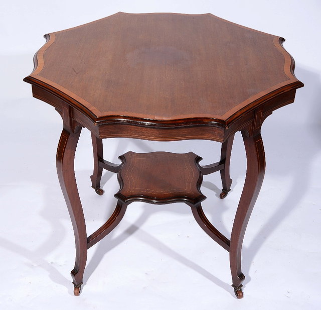 Appraisal: An Edwardian mahogany and satinwood centre tablewith shaped top cm