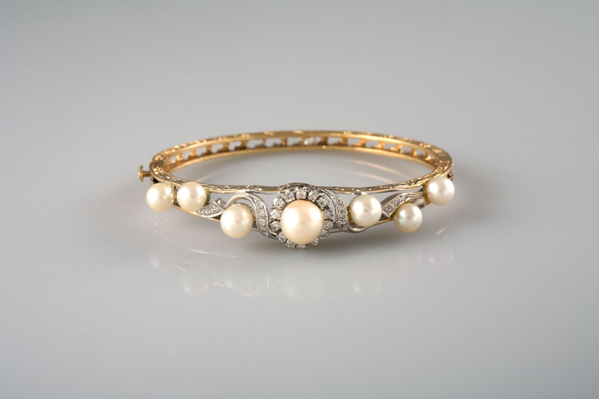 Appraisal: EDWARDIAN DIAMOND AND PEARL HINGED BANGLE BRACELET Set with seven