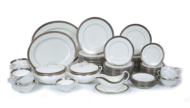 Appraisal: A COALPORT DINNER SERVICE with silver border with arch decoration