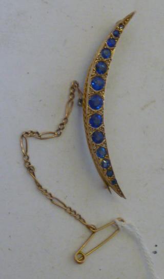 Appraisal: A SAPPHIRE CRESCENT BROOCH the graduated round cut sapphires set