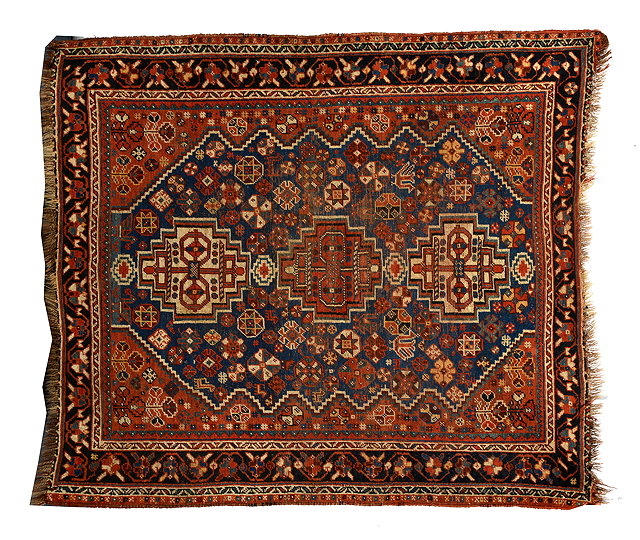 Appraisal: AN OLD SHIRAZ BLUE GROUND RUG with stylised design to