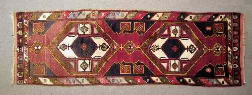 Appraisal: A Caucasian runner possibly Konya woven in primary colours with