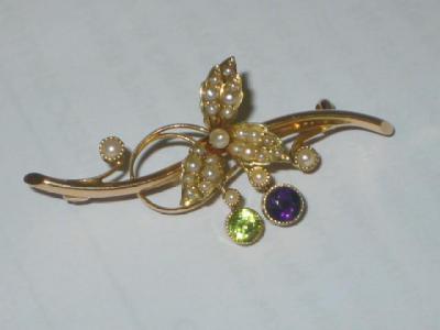 Appraisal: A VICTORIAN AMETHYST PEARL AND PERIDOT BROOCH modelled as a