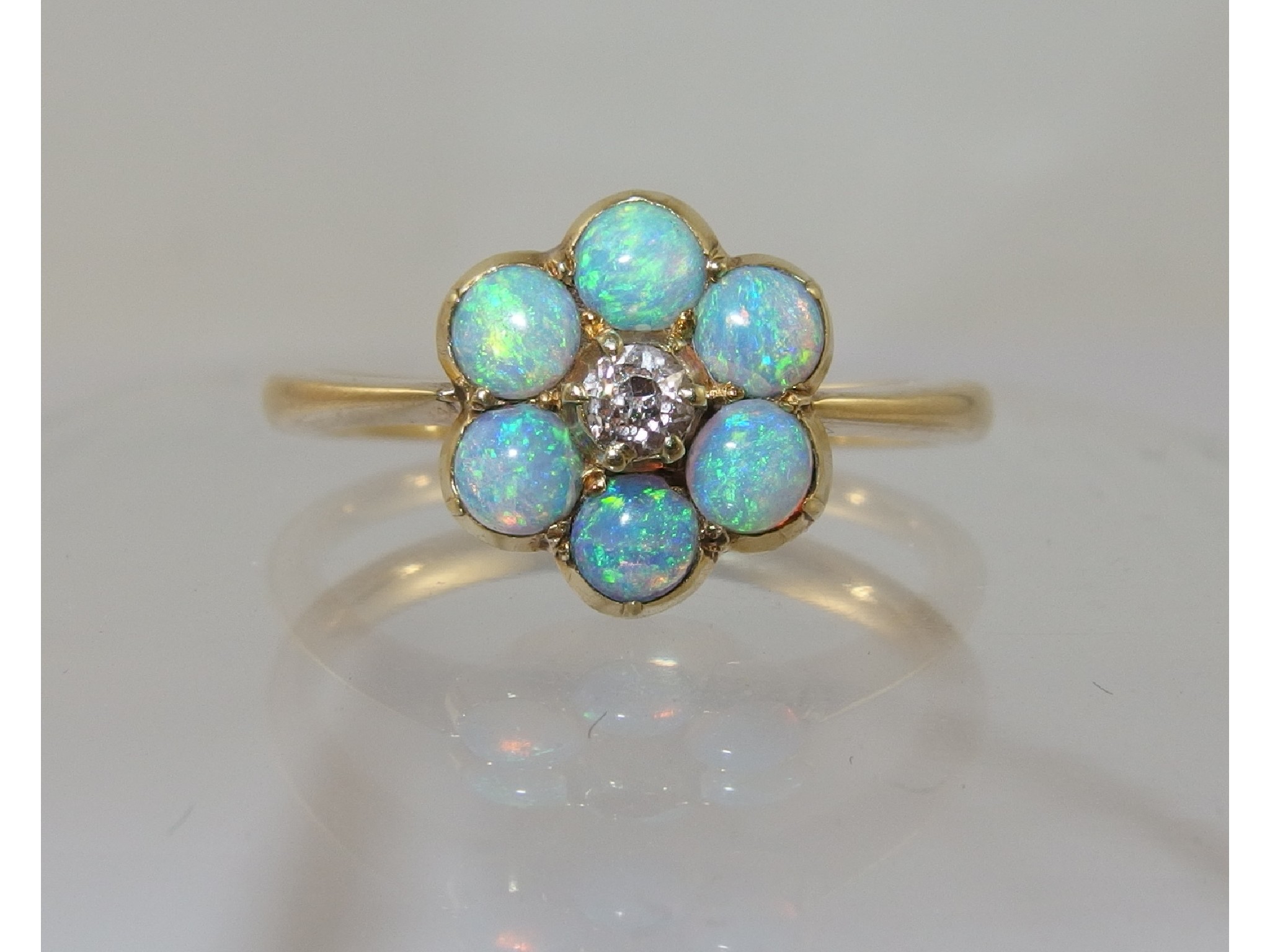 Appraisal: An opal and diamond flower ringthe six round cabouchon opals