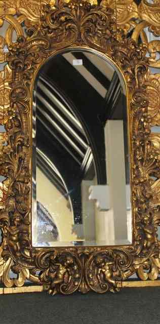 Appraisal: A MODERN GILT MIRROR with profuse cherub and acanthus floral