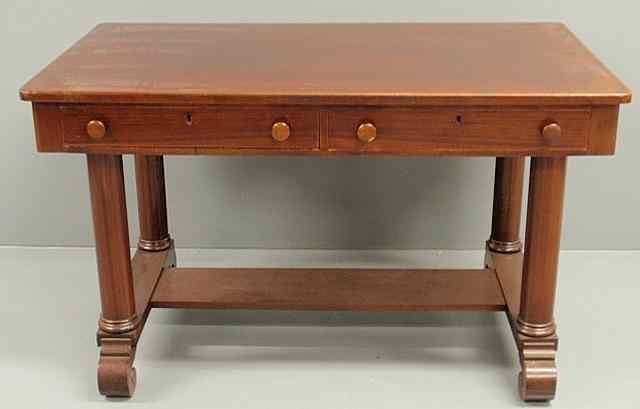 Appraisal: Empire style mahogany desk with column form legs and scroll