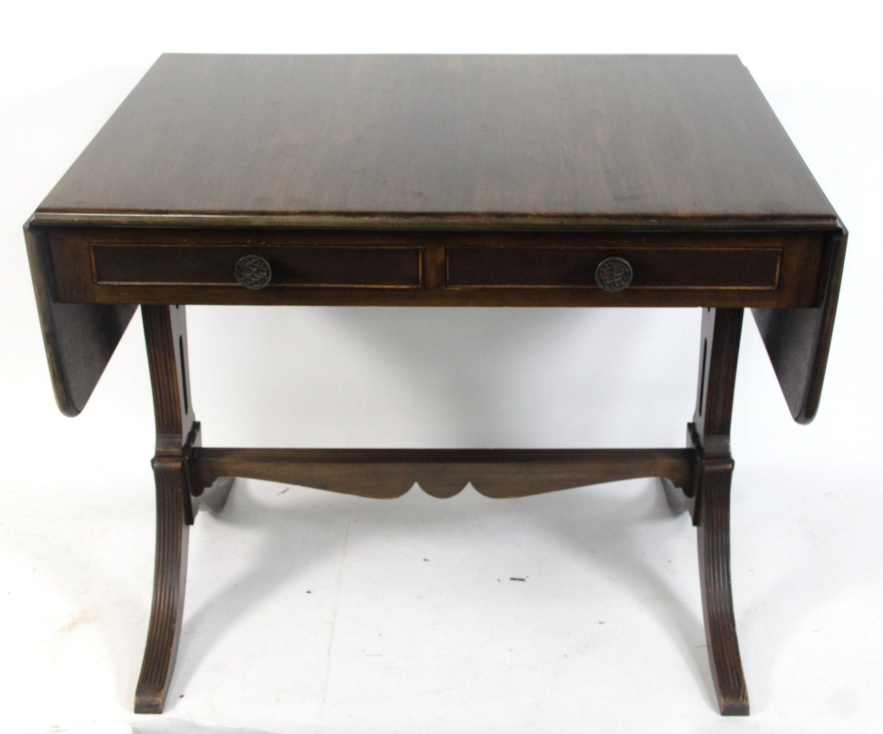 Appraisal: A mahogany two-flap sofa table on shaped end standards and