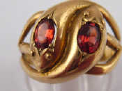 Appraisal: A carat gold garnet set double snake ring Birmingham grams