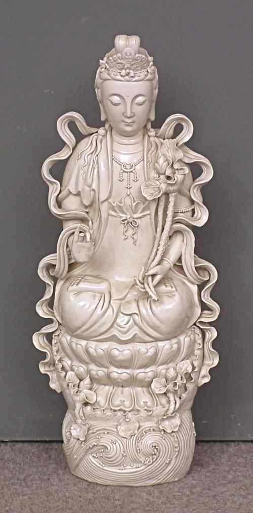 Appraisal: A Chinese blanc-de-chine porcelain figure of the seated Guanyin holding