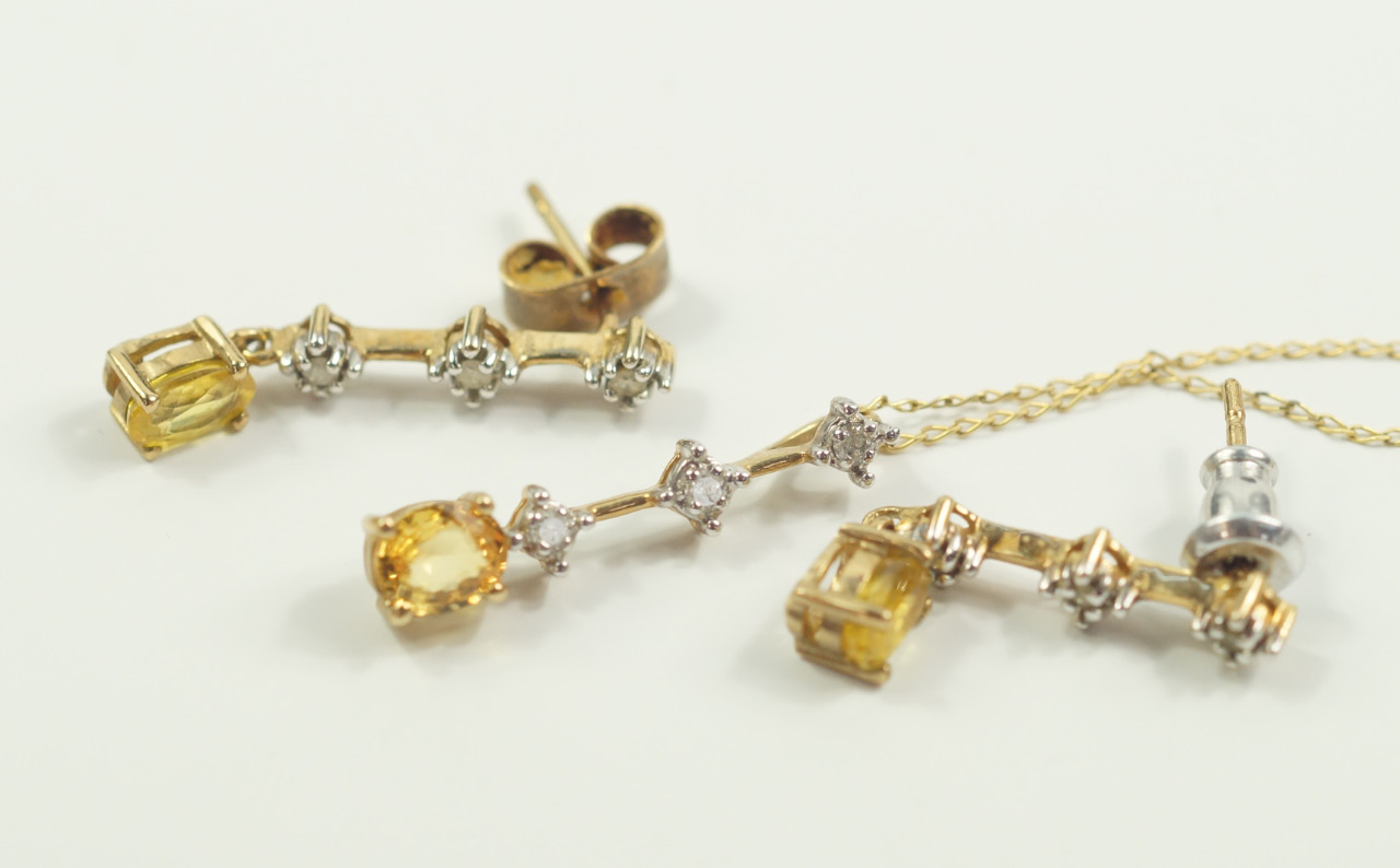 Appraisal: A yellow metal citrine and diamond pendant on chain and