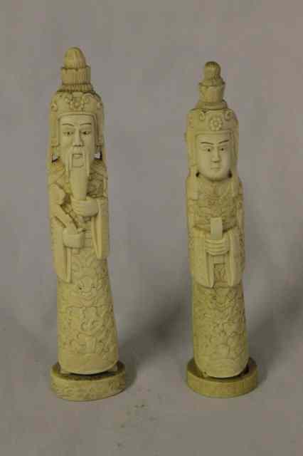 Appraisal: A PAIR OF CHINESE CARVED IVORY MODELS OF AN EMPEROR